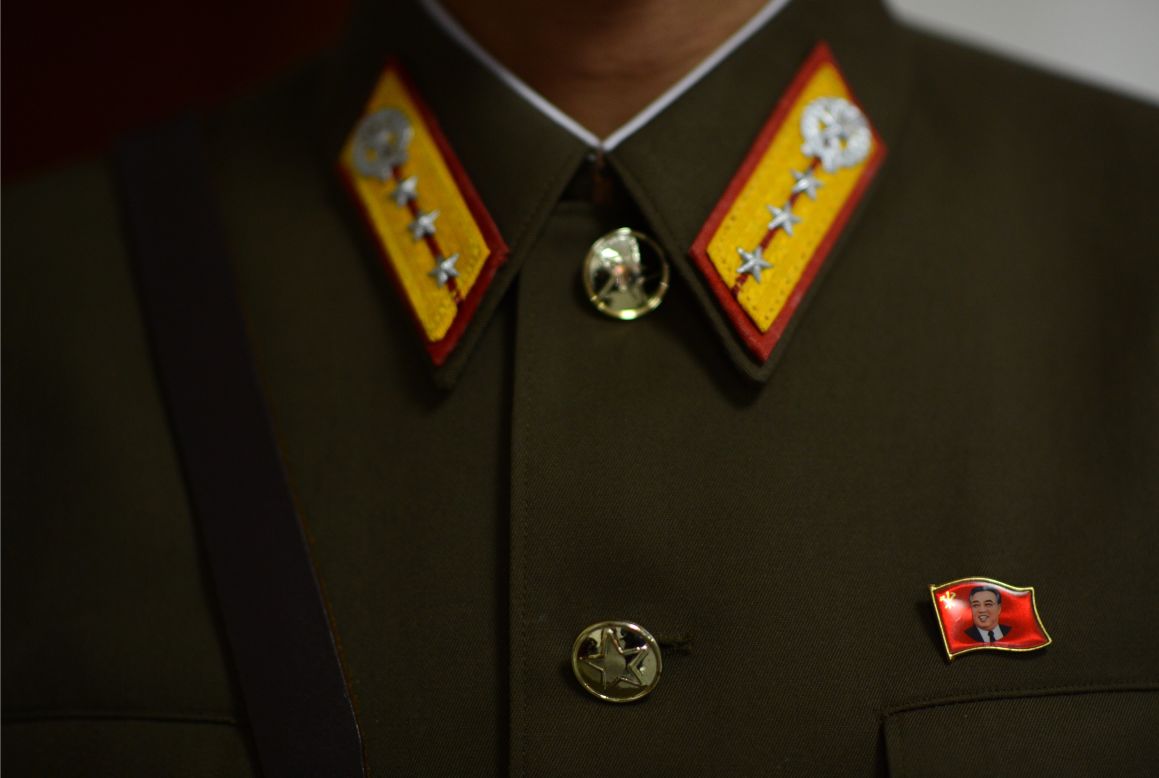 A pin with the face of Kim Il-Sung is affixed to the uniform of a North Korean soldier standing guard at the space center in Pyongyang on Wednesday, April 11.