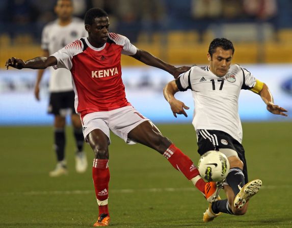 Hassan challenges Kenya's Raphael Mungai Kiongera during a friendly football match in Doha, Qatar, on February 27. It was his 179th appearance for  Egypt, making him the most-capped international footballer in history.