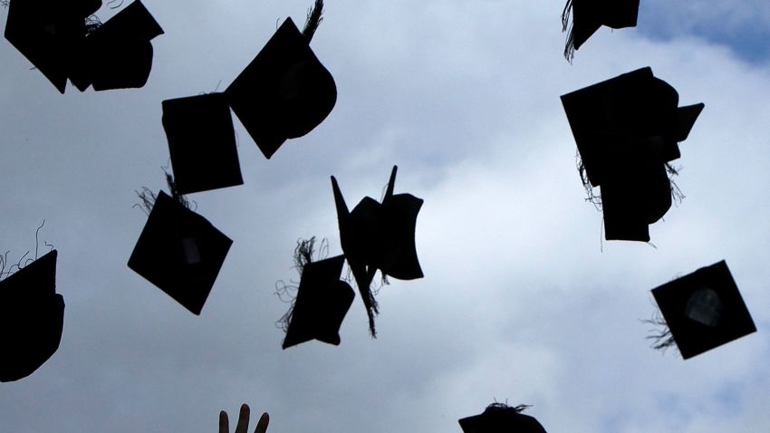 BIRMINGHAM, ENGLAND - JULY 14: Students throw their mortarboards in the air during their graduation photograph at the University of Birmingham degree congregations on July 14, 2009 in Birmingham, England.