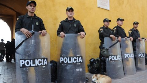 Riot police stand guard next to the media center of the Summit of the Americas in Cartagena, Colombia.