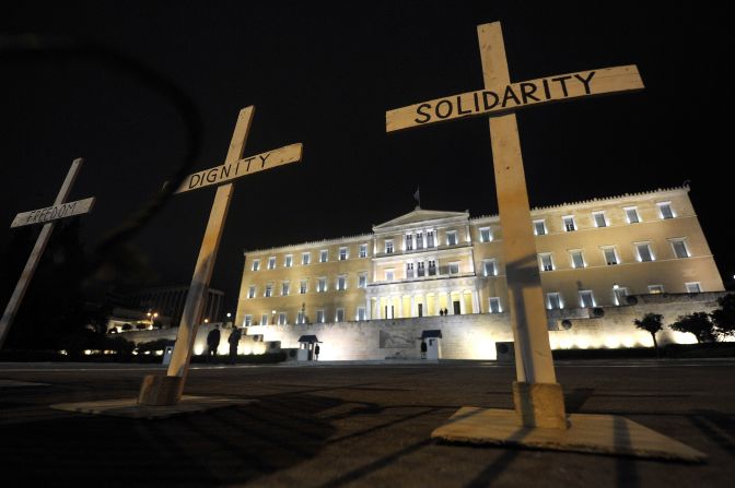 Crosses reading "Solidarity," "Dignity"' and "Freedom" are placed before Greek parliament during a gathering at Syntagma Square on  April 8, 2012. Protesters gathered after the suicide of pensioner Dimitris Christoulas, who cited austerity measures as a reason.