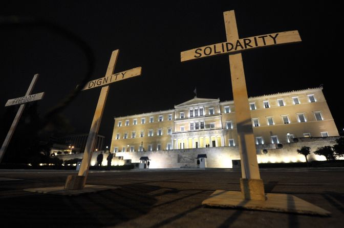 Crosses reading "Solidarity," "Dignity"' and "Freedom" are placed before Greek parliament during a gathering at Syntagma Square on April 8, 2012. Protesters gathered after the suicide of pensioner Dimitris Christoulas, who cited austerity measures as a reason.