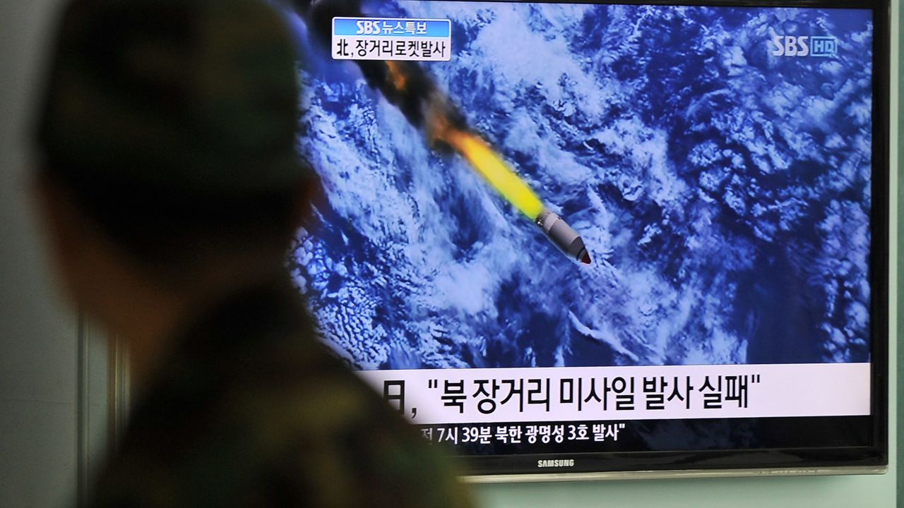 South Korean people watch a TV screen showing a graphic of North Korea's rocket launch, at a train station in Seoul on April 13, 2012. 