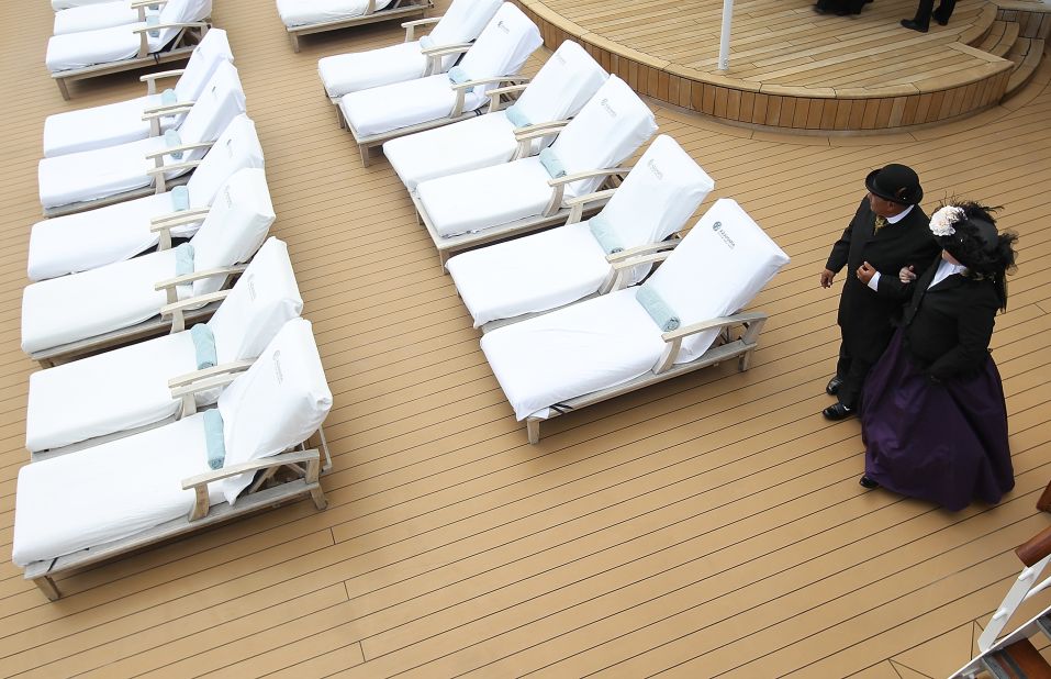 Laurie and Dan Castaneda of Long Beach, California, walk on the deck of the Azamara Journey in period clothing. 