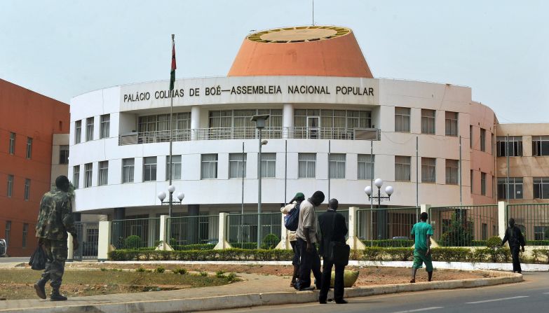 Residents walk past the Parliament in Bissau, capital of Guinea-Bissau. African countries rank as at high risk in the index, partly due to their natural susceptibility to events such as floods, droughts, fires, storms or landslides. But their high ranking is also a product of the vulnerability of the population and the inadequacies of existing infrastructure to adapt to or tackle climate change challenges because of weak economies, governance, education and health care.