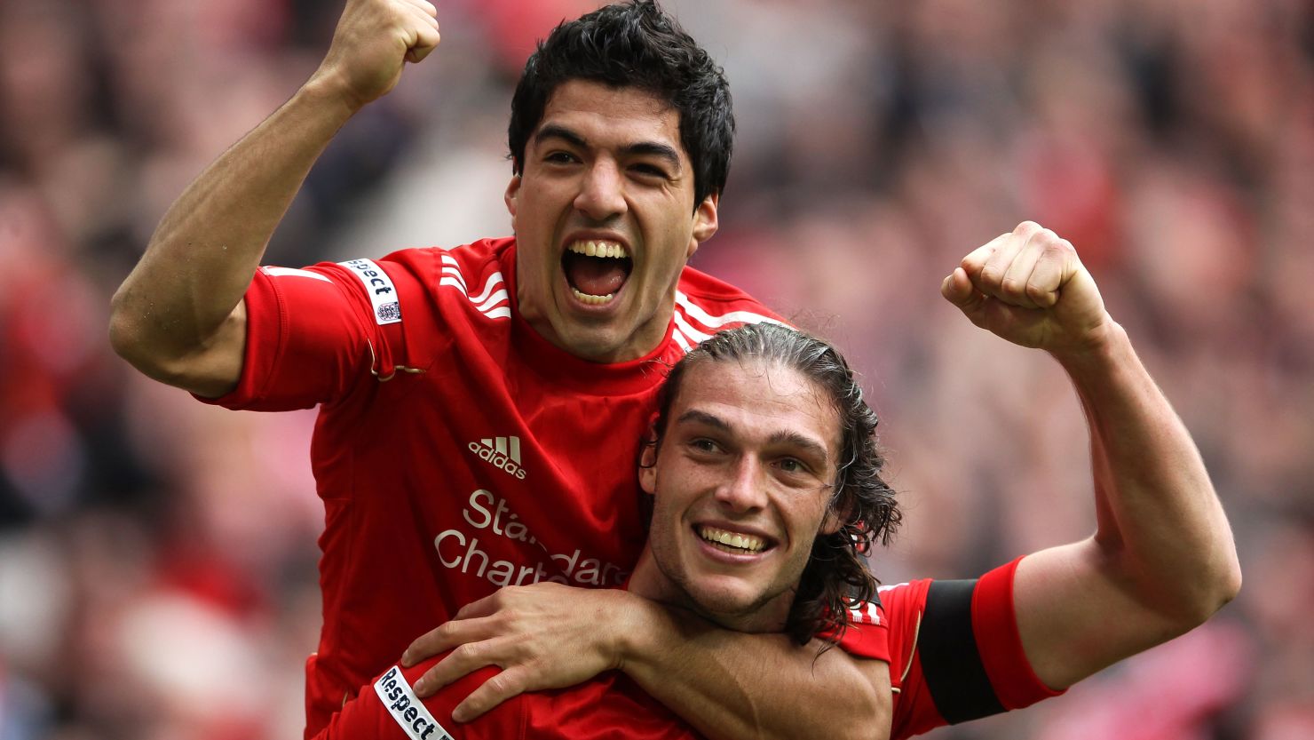 Liverpool's Andy Carroll (r) celebrates with Luis Suarez after scoring the winning goal against Everton in the FA Cup semifinal 