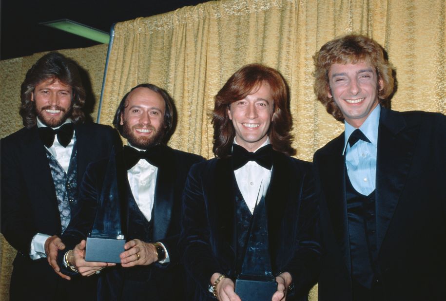 The Bee Gees pose with Barry Manilow at the American Music Awards in1979. Manilow won the award for Favorite Pop/Rock Male Artist, and the Bee Gees won Favorite Pop/Rock Band, Duo, or Group.