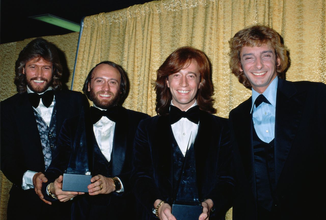 The Bee Gees pose with Barry Manilow at the American Music Awards in1979. Manilow won the award for Favorite Pop/Rock Male Artist, and the Bee Gees won Favorite Pop/Rock Band, Duo, or Group.