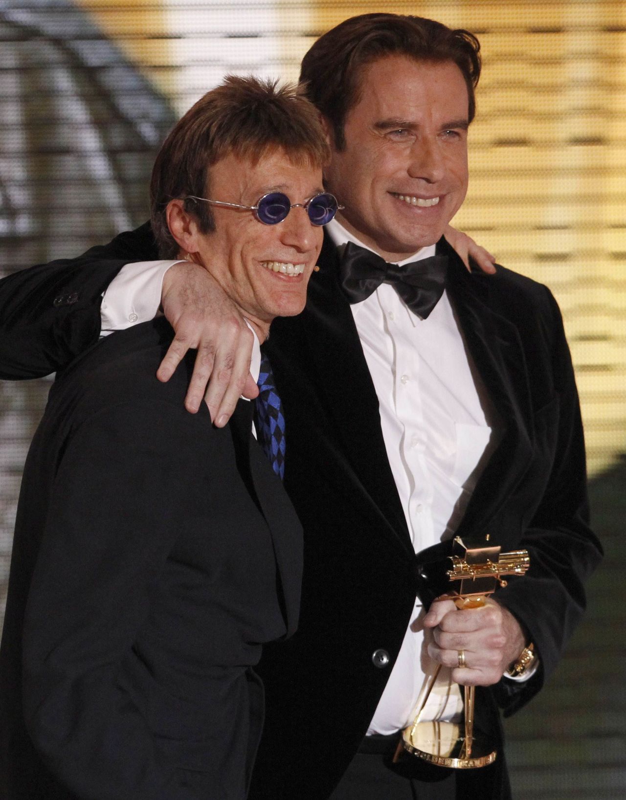 Robin Gibb and John Travolta pose after Gibb announced Travolta as the winner of a Golden Camera media prize in Berlin in February 2010.