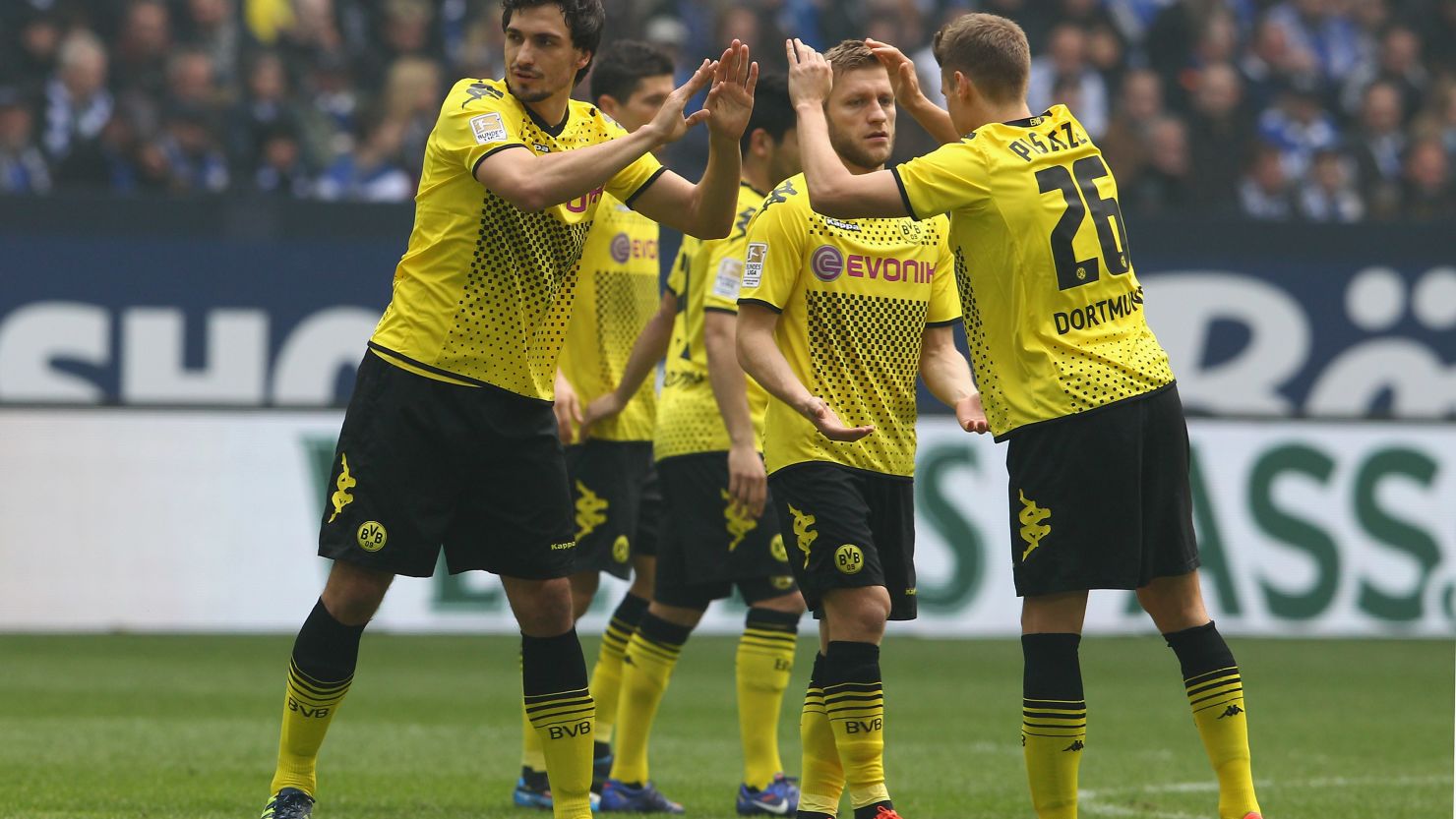 Borussia Dortmund players congratulate each other after beating Schalke on Saturday to all but seal the Bundesliga title