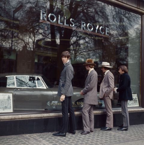 The Bee Gees, formerly known as The Brothers Gibb, pose in front of a Rolls Royce showroom in 1967.