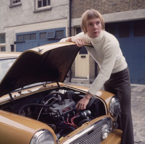 Australian musician Colin Petersen, a drummer with the popular disco group The Bee Gees, tinkering under the hood of his car in 1965.