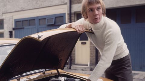 Australian musician Colin Petersen, a drummer with the popular disco group The Bee Gees, tinkering under the hood of his car in 1965.
