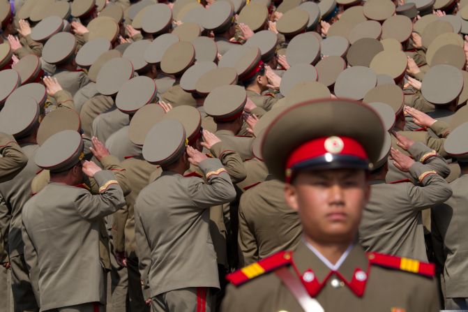 North Korean soldiers salute during Sunday's military parade.
