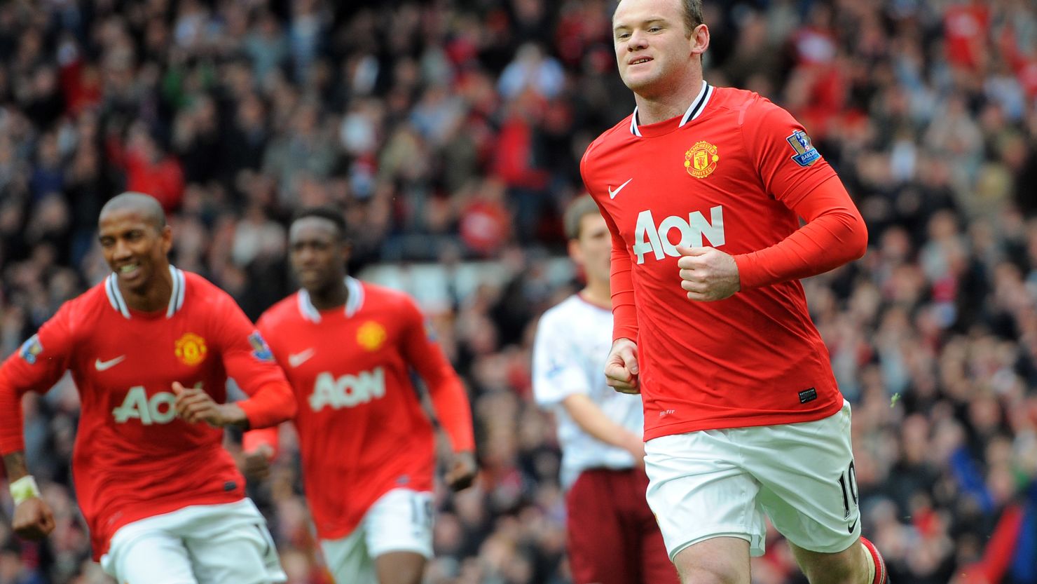 Wayne Rooney celebrates his opening goal from the penalty spot at Old Trafford.