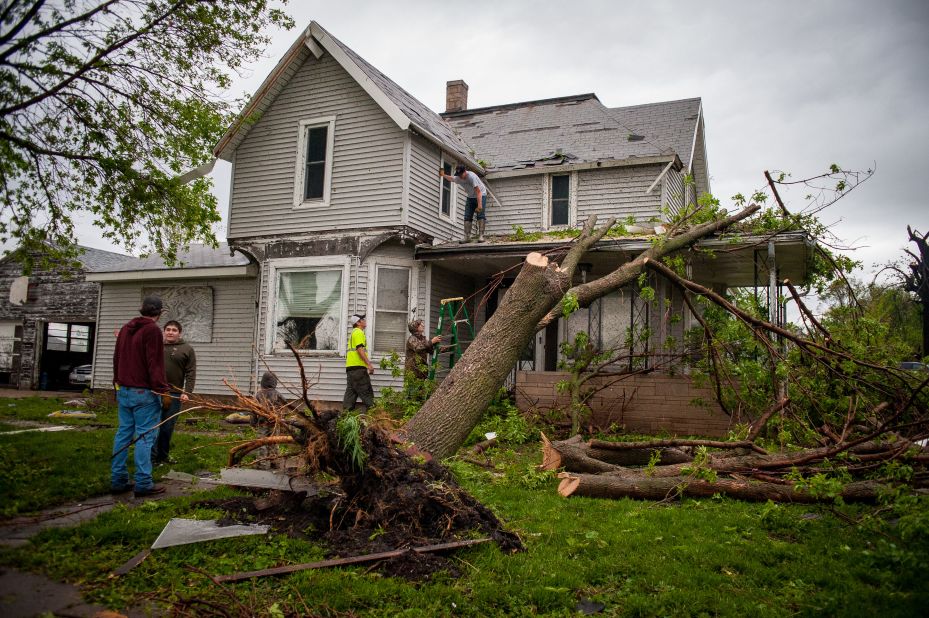 Residents clean up in the aftermath of the storm on Saturday,  in Thurman. 