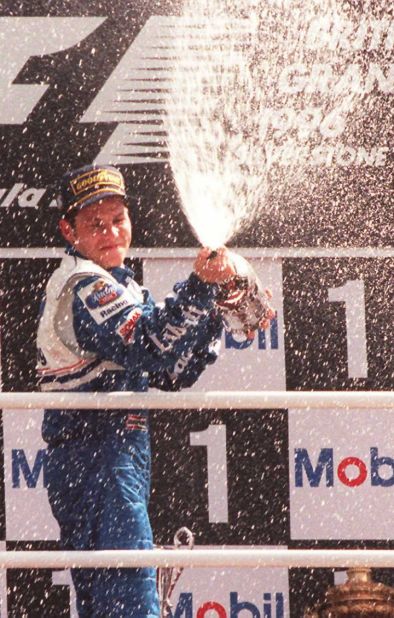 Jacques Villeneuve showers the crowd with champagne after winning the1994 British Grand Prix. He became the first Canadian to win the world title three years later -- a feat his father Gilles could not manage. 