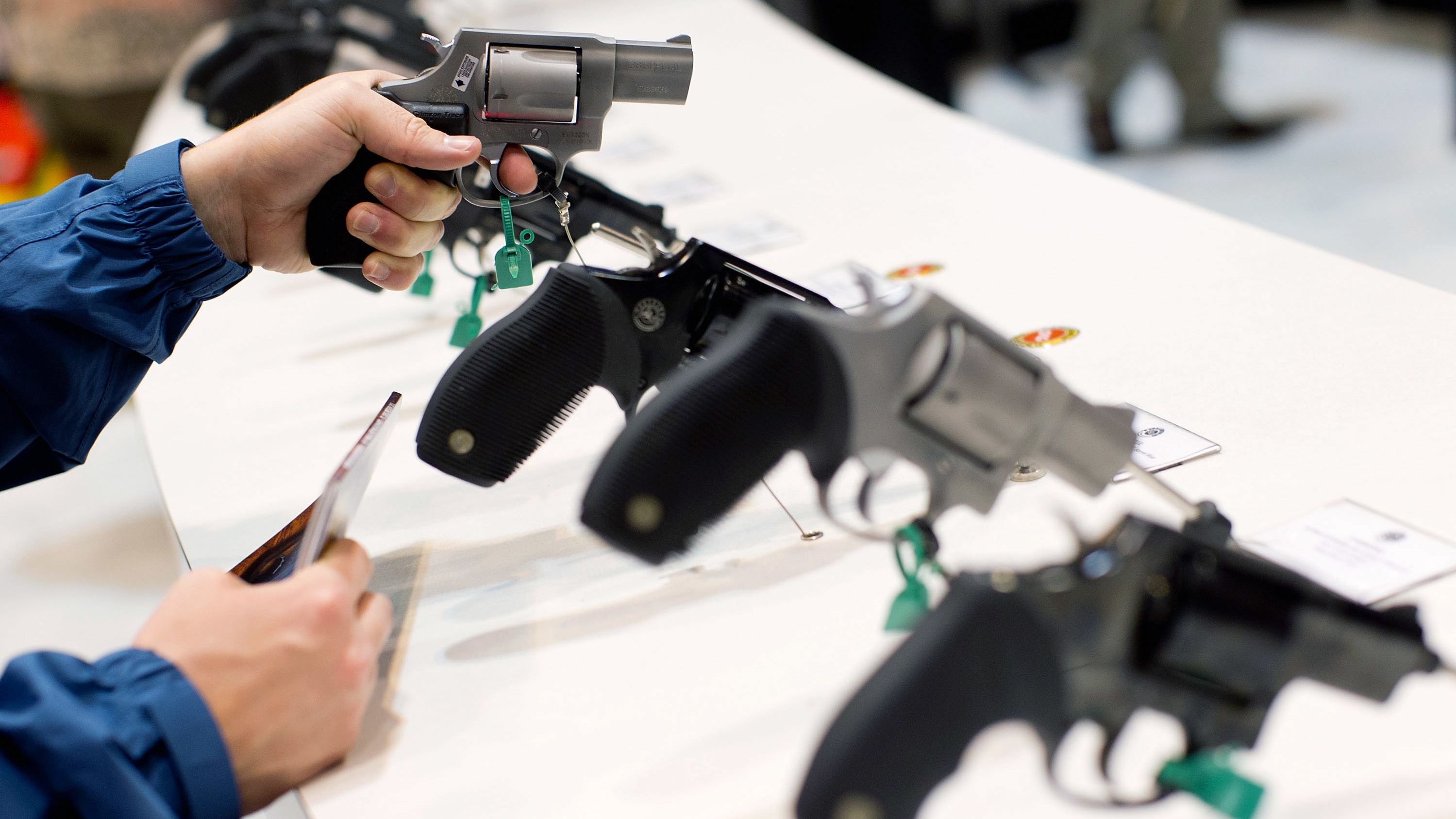 A visitor looks at a Taurus revolver during the National Rifle Association's annual meeting Friday in St. Louis. 