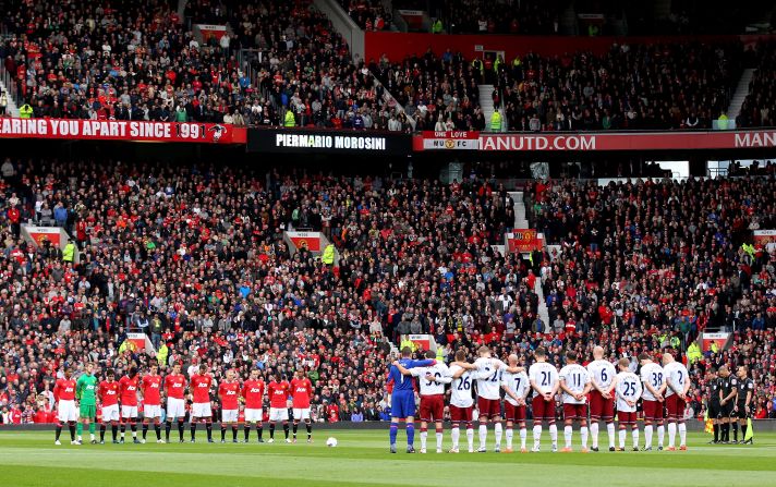 Manchester United and Aston Villa players bow their heads in silence during a one-minute tribute to Morosini before Sunday's English Premier League match at Old Trafford.