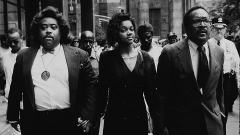 Tawana Brawley holds hands with Al Sharpton, left, in 1990. 
