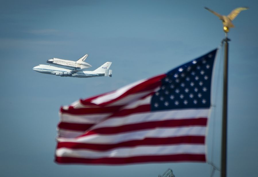 Discovery flies over the National Mall on Tuesday as it arrives from Kennedy Space Center in Florida. The space shuttle Enterprise, which has been on display at the Smithsonian's Steven F. Udvar-Hazy Center since 1985, will be moved to the Intrepid Sea, Air & Space Museum in New York.
