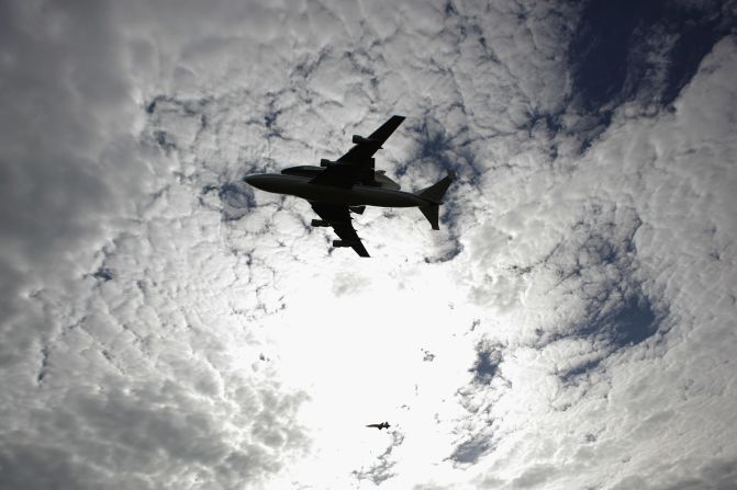 Discovery and its 747 jumbo jet carrier pass over the Smithsonian National Air and Space Museum annex in Chantilly, Virginia, on Tuesday. The shuttle will be removed from the modified jet and star as the guest of honor at a four-day celebration punctuated by a ceremony Thursday formally welcoming Discovery to the Smithsonian collection.