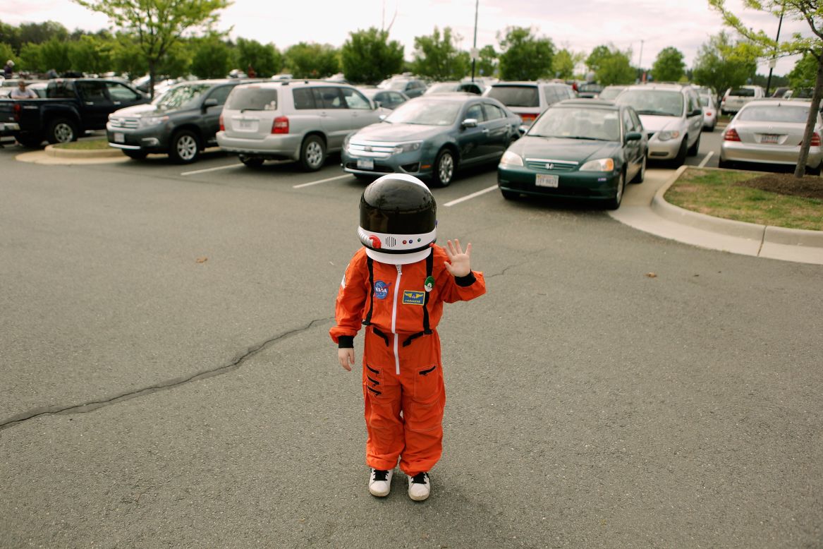 An aspiring astronaut poses in the parking lot of the Smithsonian National Air and Space Museum Steven F. Udvar-Hazy Center on Tuesday in Chantilly.