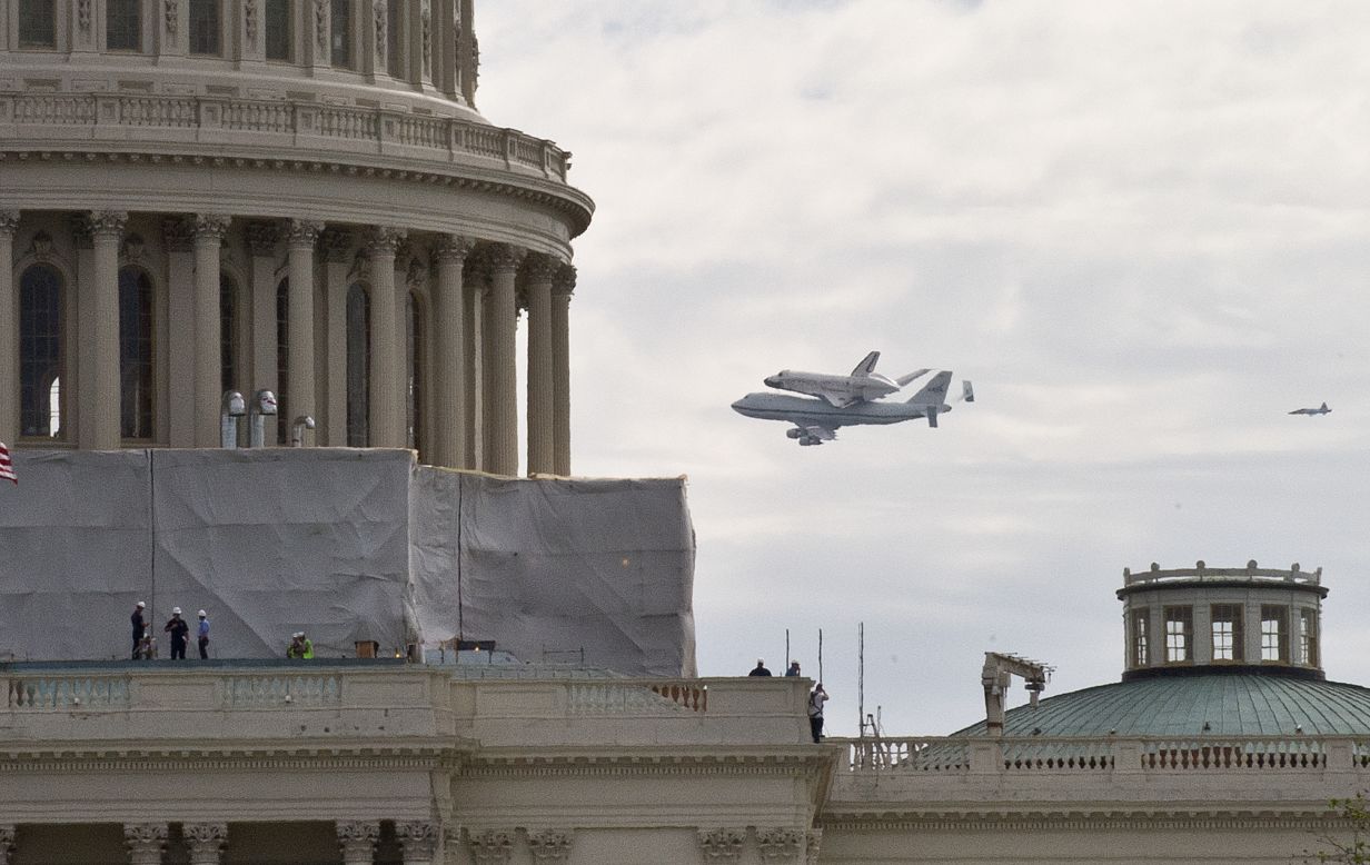 Shuttle Discovery flies past the U.S. Capitol in Washington on Tuesday.