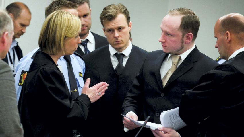 State prosecutor Inga Bejer Engh (L) speaks with Anders Behring Breivik (2nd R) on second day of Breivik's trial.