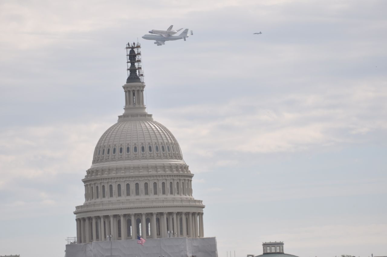 Discovery flies over the Capitol in Washington. It made several passes over the National Mall, drawing cheers from the crowds that gathered to watch it.