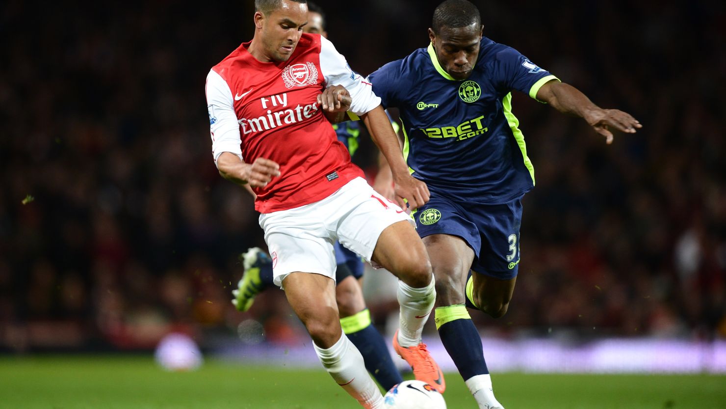 Arsenal's Theo Walcott is challenged by Maynor Figueroa of Wigan during Monday's English Premier League match.