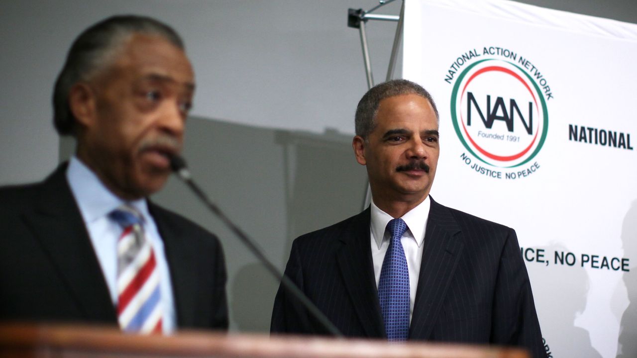 Eric Holder, right, faces criticism for his appearance last week at an annual convention held by the Rev. Al Sharpton's group.