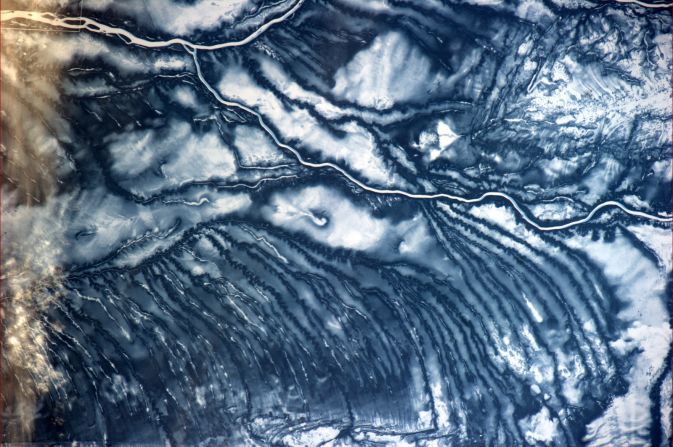 The International Space Station (ISS) orbits at a height of around 400 kilometers above the Earth's surface and travels at 20,000 kilometers-per-hour.