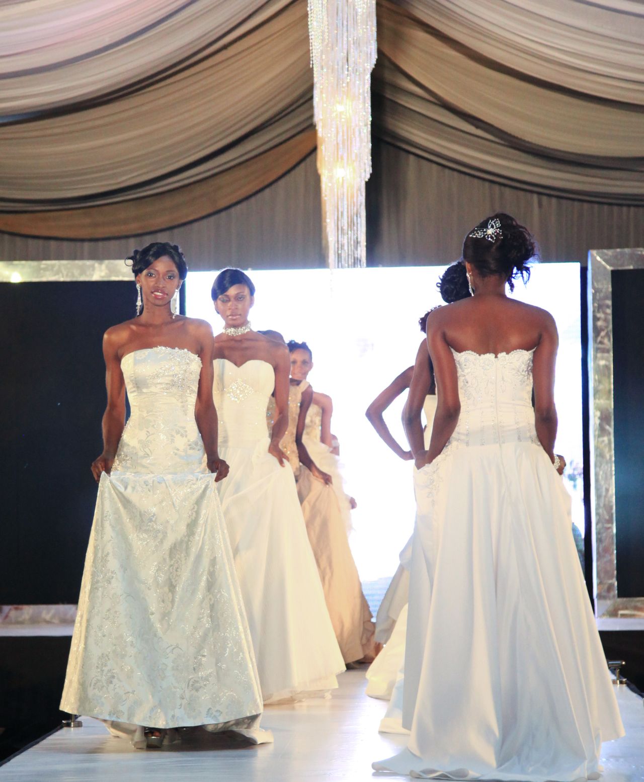 Models wear bridal gowns on the runway at a Lagos Wed Expo wedding exhibition. Organizers say about 10,000 people attended over two days.