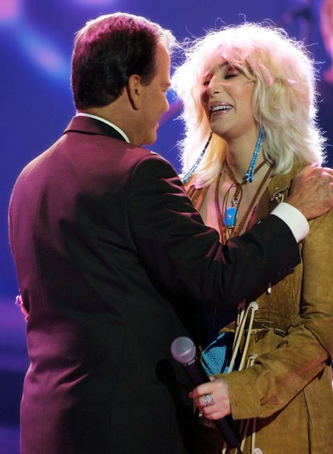 Clark and Cher hug during the taping of the 50th anniversary speical of "American Bandstand."