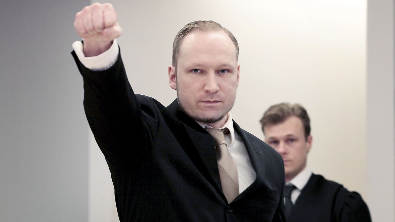Anders Behring Breivik extends a clenched fist on Tuesday in Oslo, Norway, for the second day of his trial. 