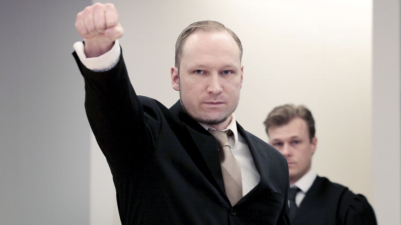 Anders Behring Breivik extends a clenched fist on Tuesday in Oslo, Norway, for the second day of his trial.