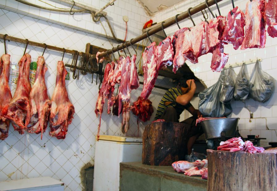 Beef hangs from meat hooks in the butcher's quarter of Nizamuddin, Delhi, on March 12. This year, India will displace the United States as the world's third largest beef exporter.