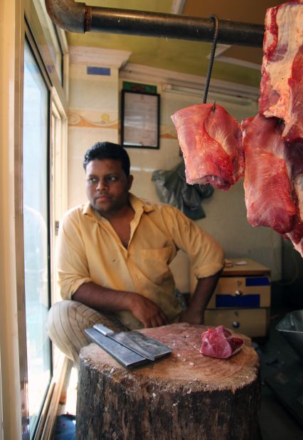 The cashier at Qureshi's butchery looks out his window in Nizamudin, Delhi, on March 12. 
