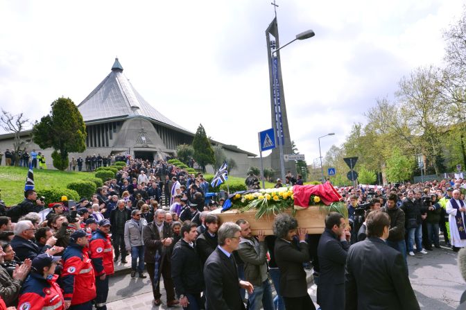 Distraught mourners follow the coffin of Piermario Morosini at the funeral service at the Church of San Gregorio in Bergamo on Thursday.