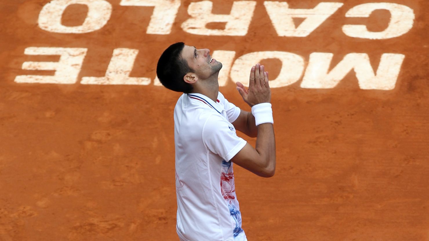 Novak Djokovic looks to the skies after his win in Monte Carlo, just hours after learning of his grandfather's death
