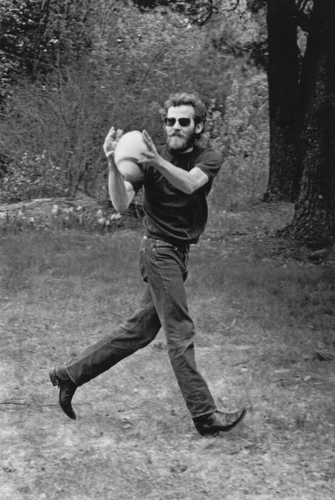 Helm catches a football outside his house, Bearsville, in Woodstock, New York, in 1968.
