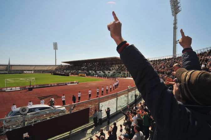 Mourners salute Morosini as a hearse carrying his coffin does a lap of the  stadium. 