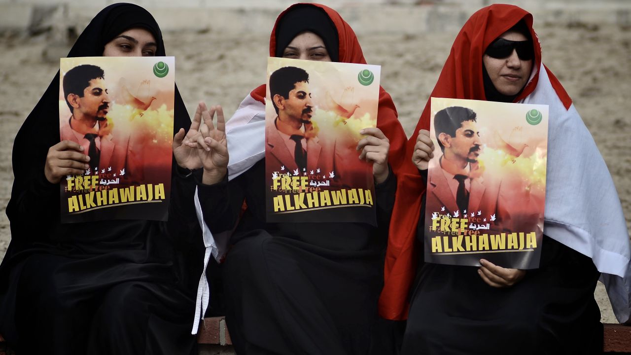 Bahraini demonstrators hold posters of Abdulhadi al-Khawaja during a protest calling for his release in on April 6, 2012. 