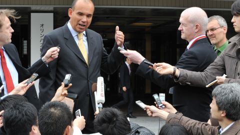 Michael Woodford (top,C), former Olympus president and chief executive officer who was dismissed from his posts last October, speaks to reporters upon his arrival at an extraordinary shareholders meeting in Tokyo on April 20, 2012. 