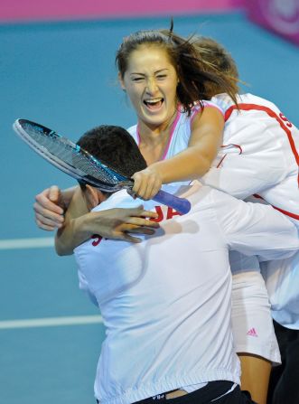 Serbia's Bojana Jovanovski celebrates her victory with coach Dejan Vranes after she helped to beat Belgium in Charleroi.