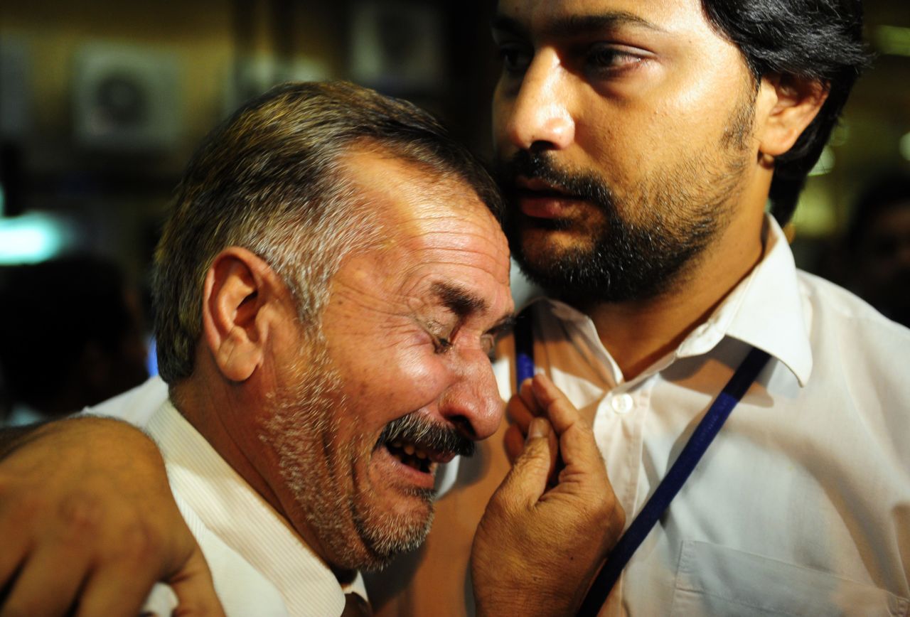 Pakistani relatives of a victim of a plane crash near Islamabad mourn at the airport in Karachi.