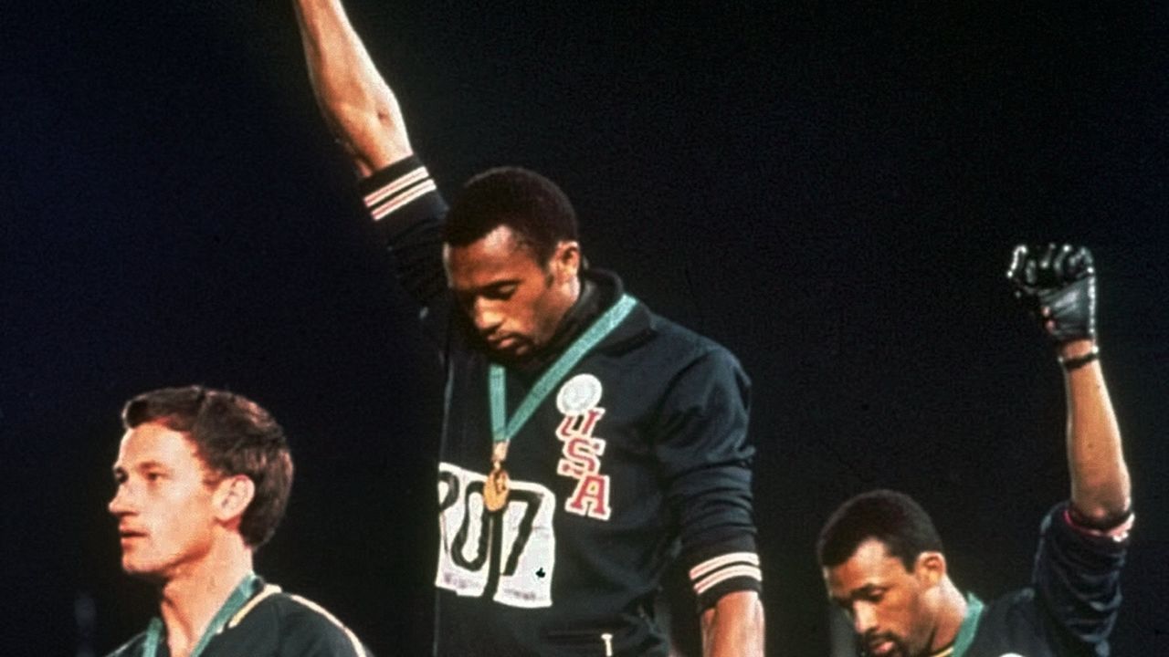 Peter Norman (left), Tommie Smith (center) and John Carlos (right) on the podium at the 1968 Mexico Olympics.