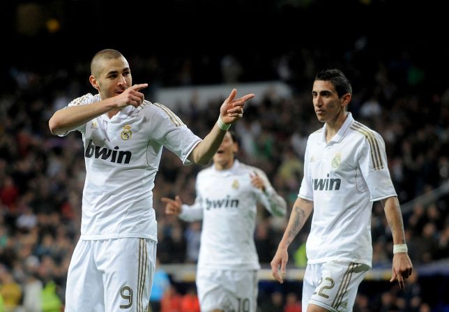 Karim Benzema celebrates his goal in Real Madrid's win over Sporting Gijon last Saturday which kept the La Liga leaders four points clear of arch-rivals Barcelona.