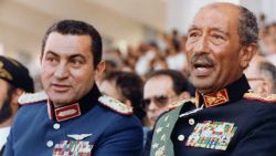 Egyptian vice President, Gen. Hosni Mubarak (L) and late President Anwar Sadat (R), both dressed in military honour uniforms, attend a military parade, 06 October 1981, in Cairo, commemorating Victory Day. Moments after, a group of military Islamist fundamentalists with allegiance to the Al-Jihad group killed Sadat in a shooting spree. Following Sadat's assassination Mubarak was sworn in as Egypt's fourth president, a position of power he has since retained, being re-elected five times. AFP PHOTO/- (Photo credit should read AFP PHOTO/AFP/GettyImages)
